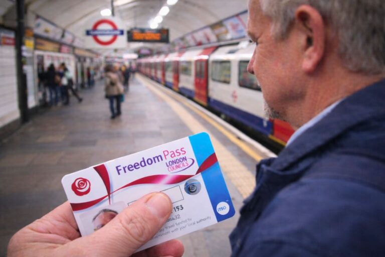 a person holding freedom pass london in his hands