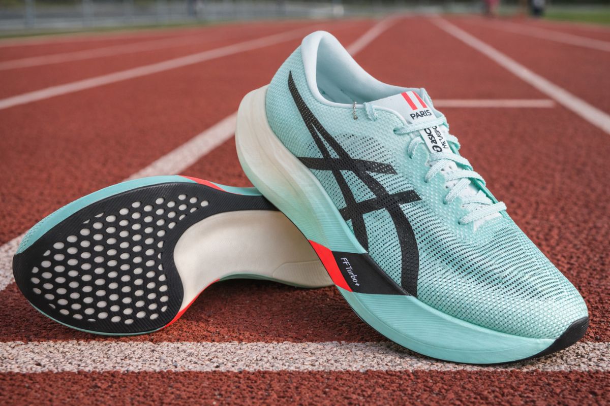 carbon plated running shoes asics metaspeed edge paris are lying on a running track