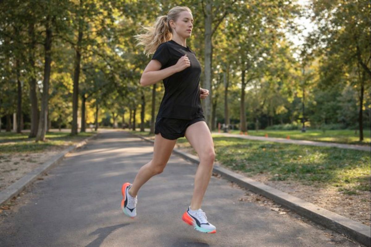 a girl running in a park wearing carbon plated running shoes puma fast r-nitro elite 3