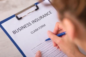uk business insurance claim form held by a person
