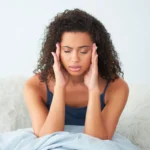 a girl having headache due to magnesium deficiency
