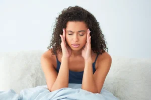 a girl having headache due to magnesium deficiency