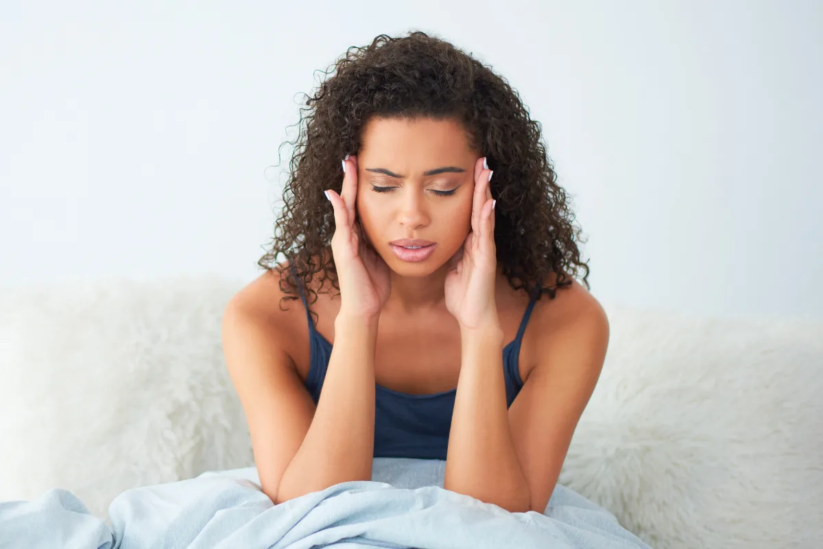 a girl having headache due to magnesium deficiency