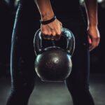 a girl doing kettlebells workout