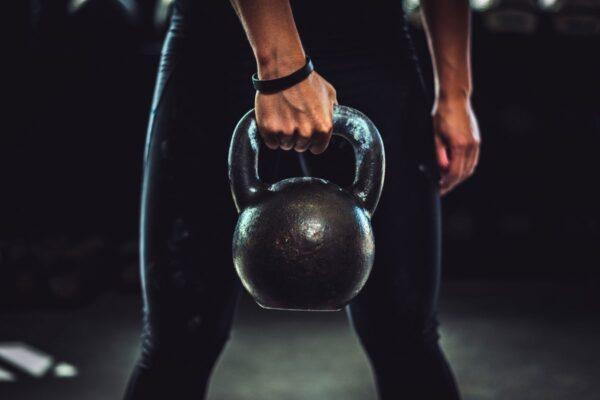 a girl doing kettlebells workout