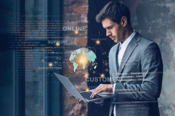 a suited person using ai agent on his laptop holding in his hands